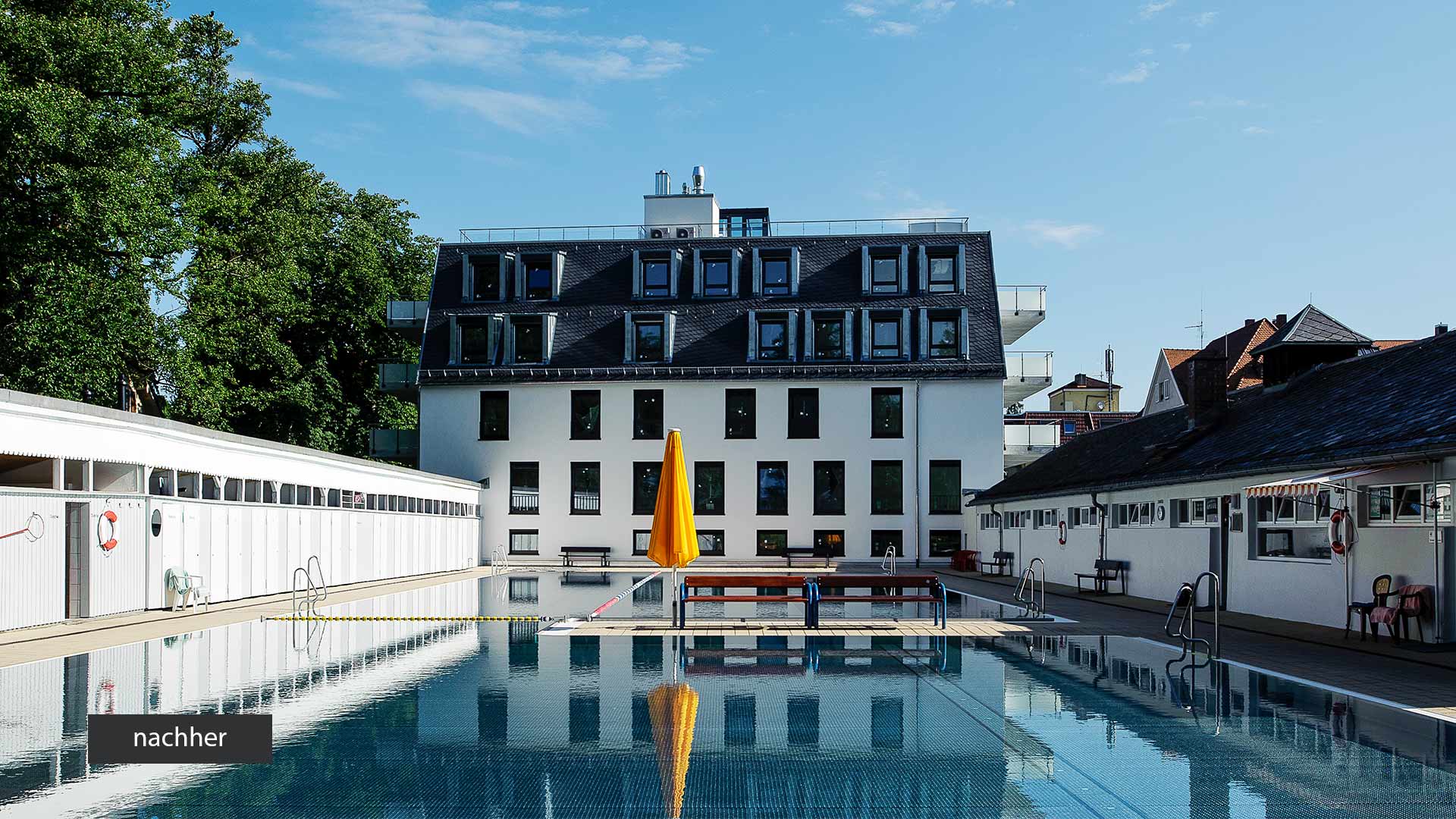 Ein fünfstöckiges saniertes Haus vor einem Schwimmbad