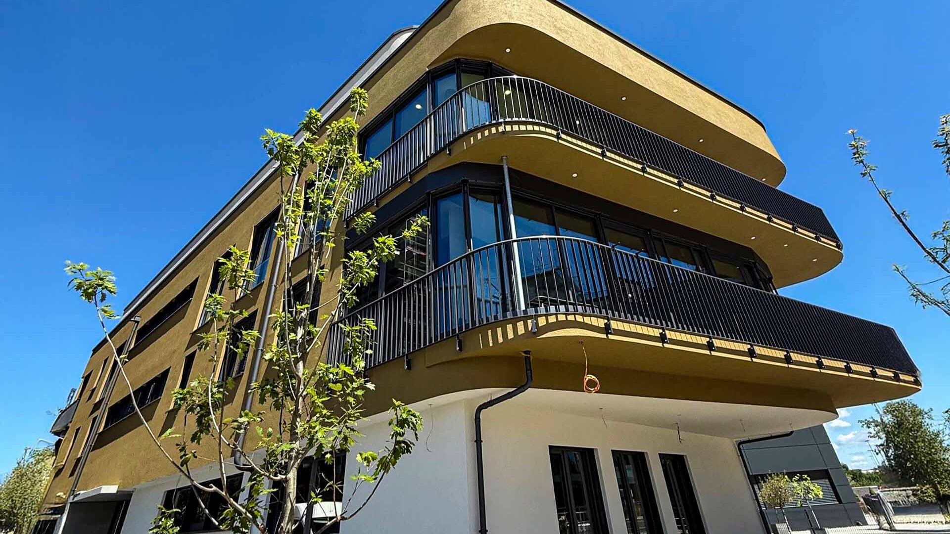 Seitliche Ansicht auf modernes Gebäude mit runden Balkonen